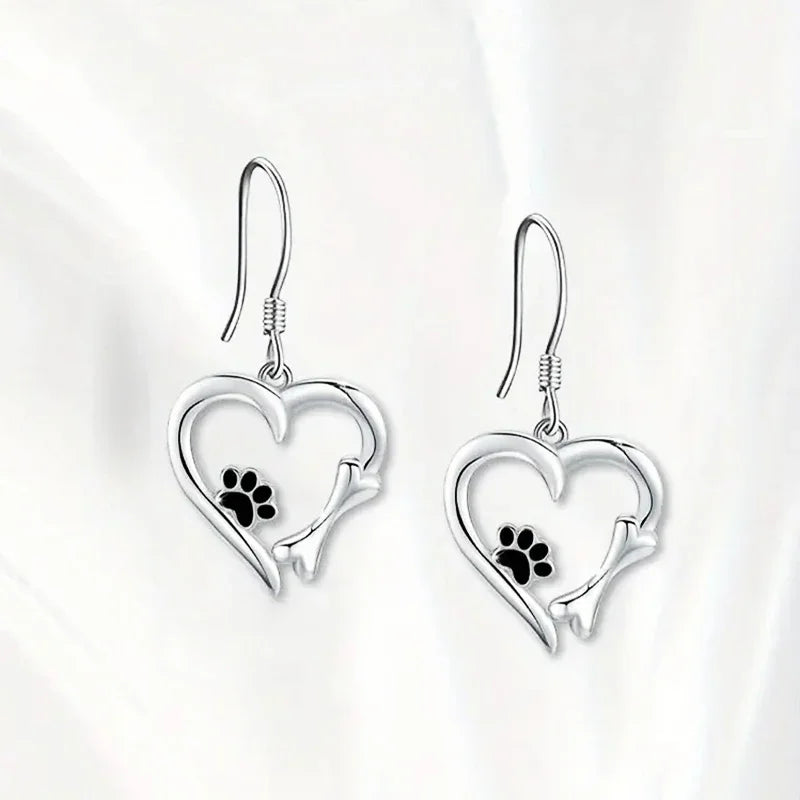 Silver dangling earrings with heart and paw print design