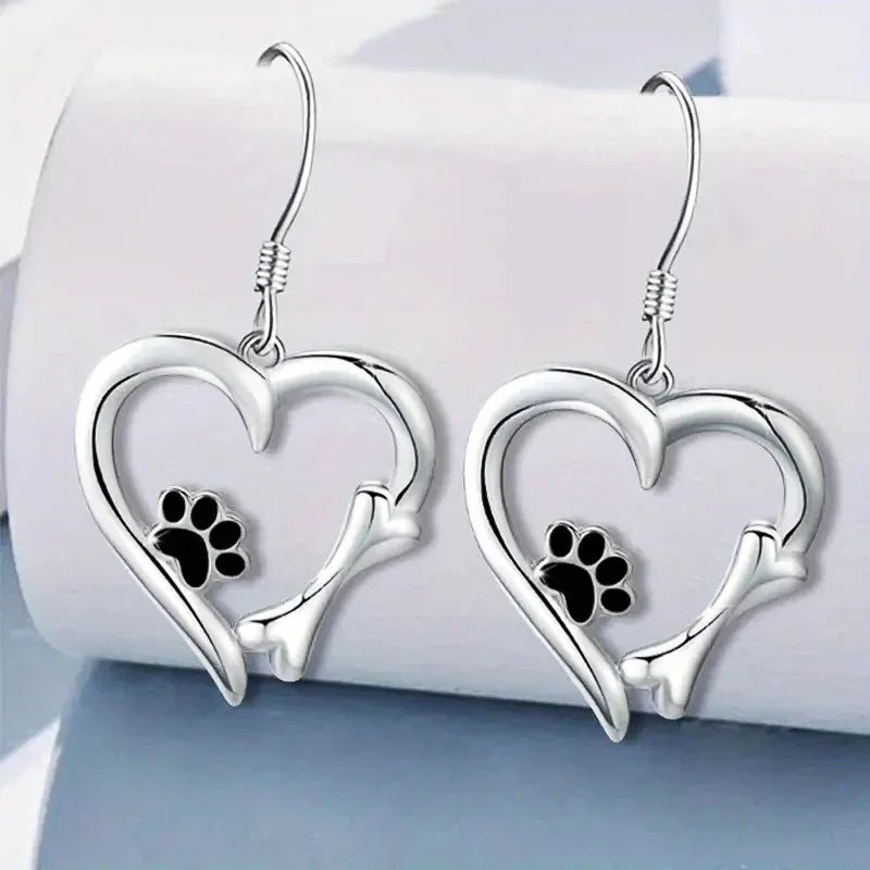 Silver dangling earrings with heart and paw print design