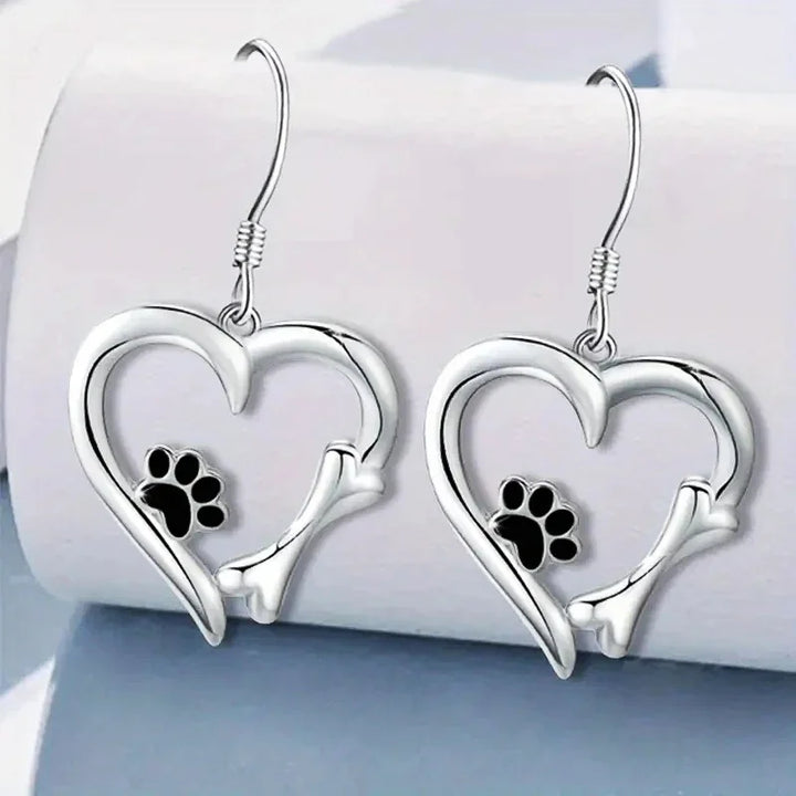 Silver dangling earrings with heart and paw print design